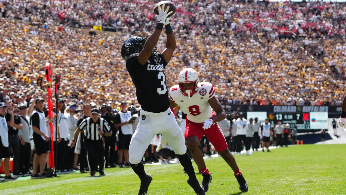 Colorado Buffaloes running back Dylan Edwards (3) reaches for the ball past Nebraska Cornhuskers cornerback.